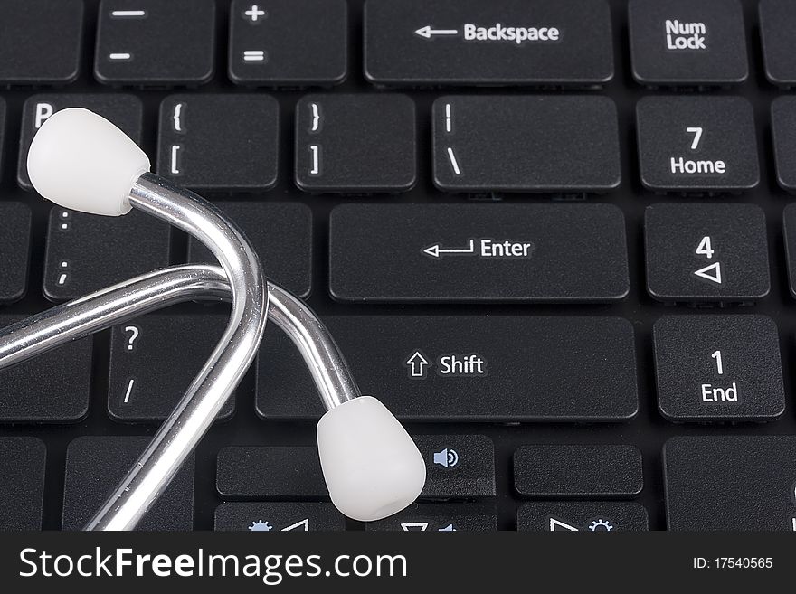 Keyboard laptop computer with a medical stethoscope. Keyboard laptop computer with a medical stethoscope.