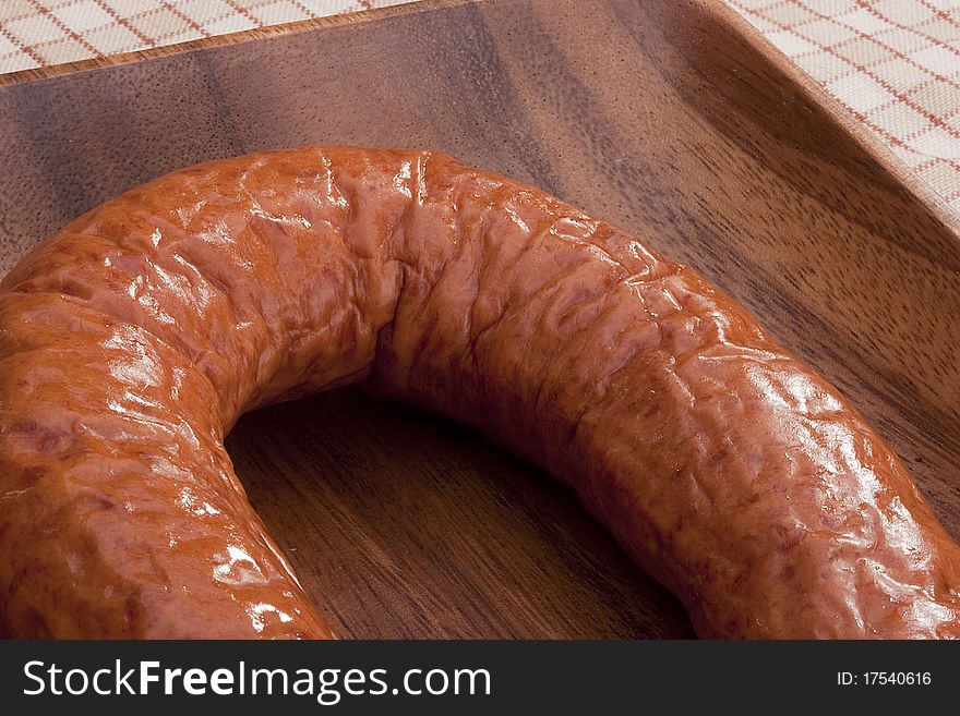 Home smoked sausage in a wooden bowl.