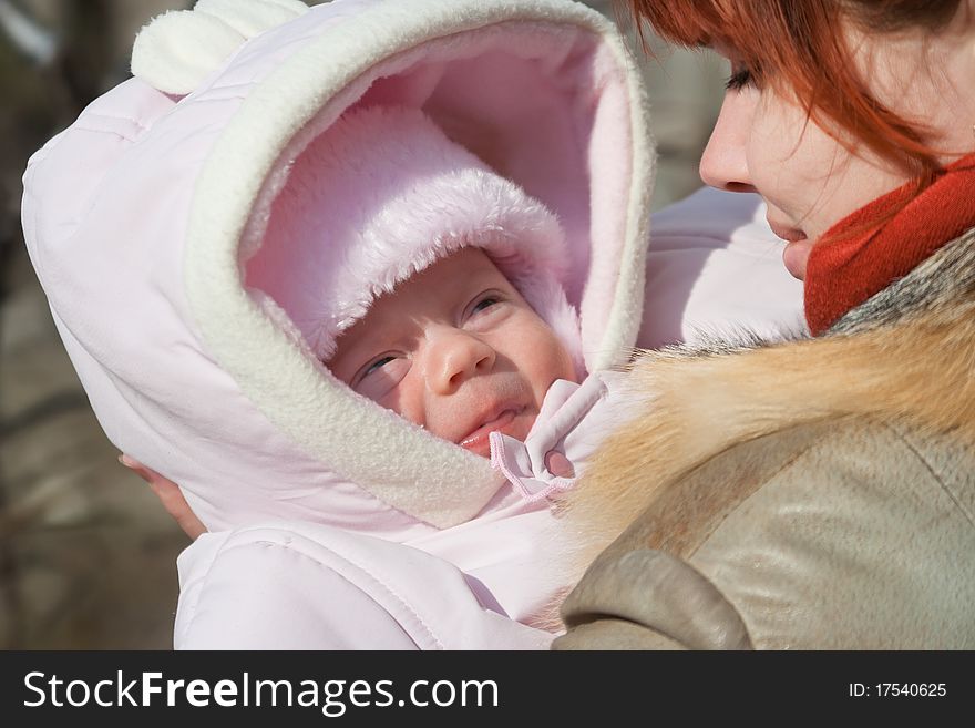 Month baby girl and mother for a walk in a spring sunny day. Month baby girl and mother for a walk in a spring sunny day