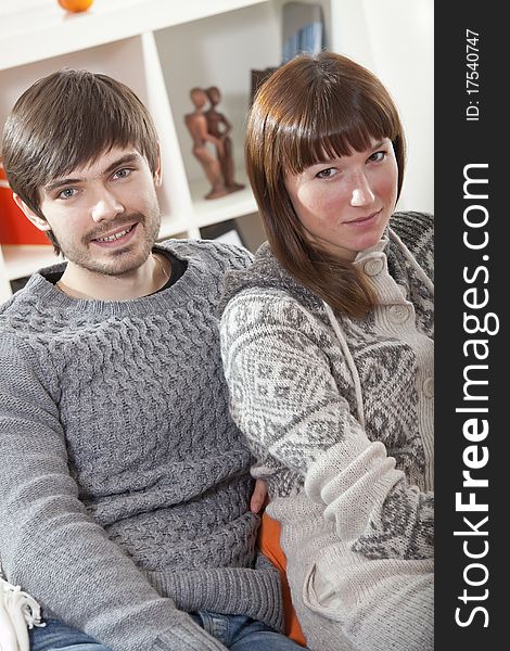 Portrait of couple sitting on sofa at home. Portrait of couple sitting on sofa at home