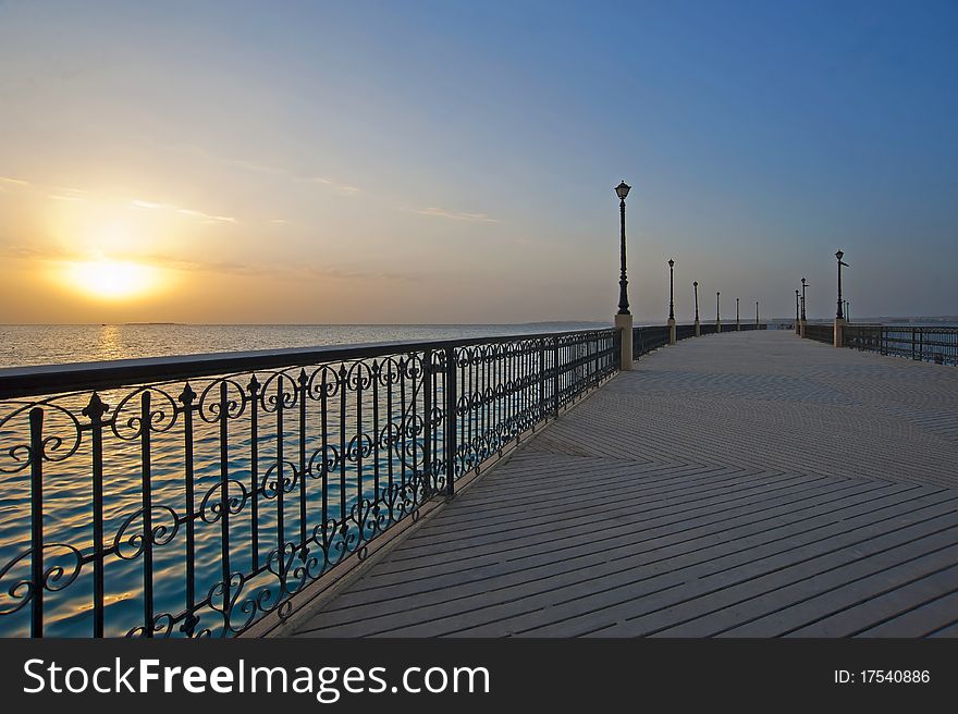 Dawn sunrise over a tropical ocean from a pier. Dawn sunrise over a tropical ocean from a pier