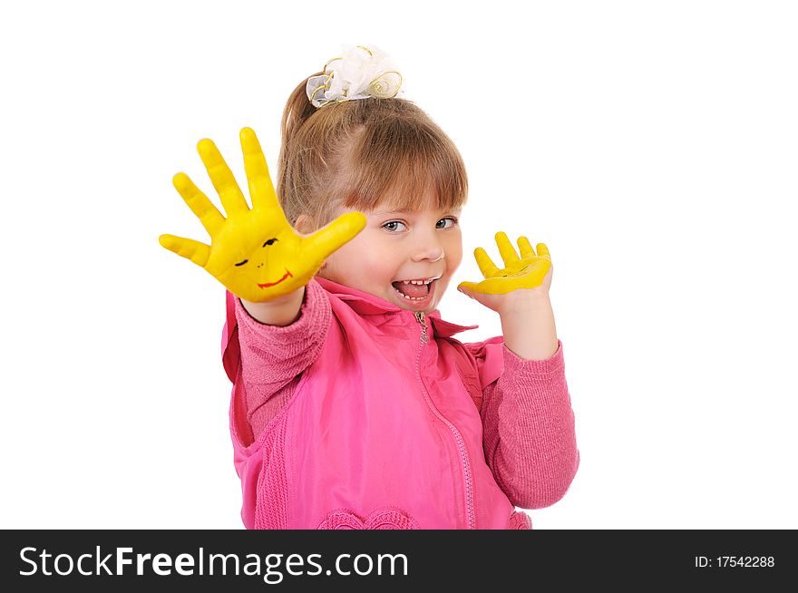 The cheerful girl keeps hands which are painted in yellow color. Isolated over white