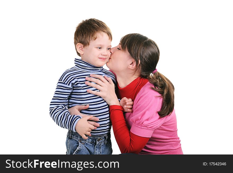 Mother kisses the small son isolated over white