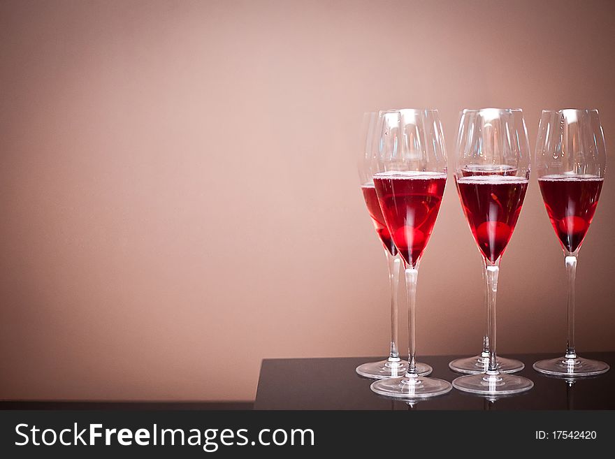 Champagne glasses with a cherry on table