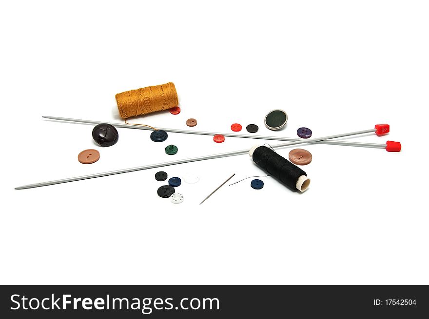 Many tools for handicraft (needle, thread, buttons) on the white background