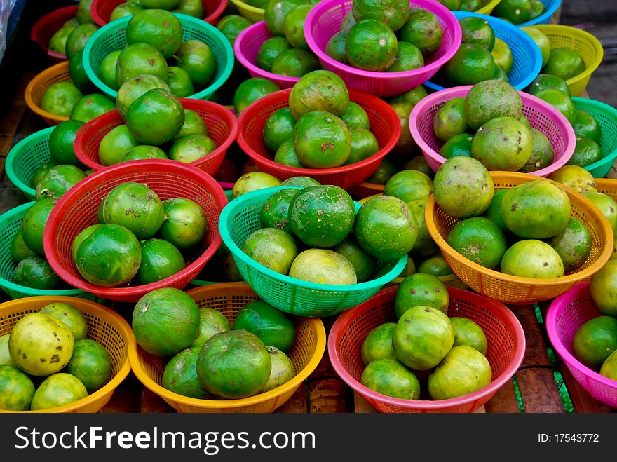 Many of fresh limes in basket in fresh market , Asia , Thailand. Many of fresh limes in basket in fresh market , Asia , Thailand