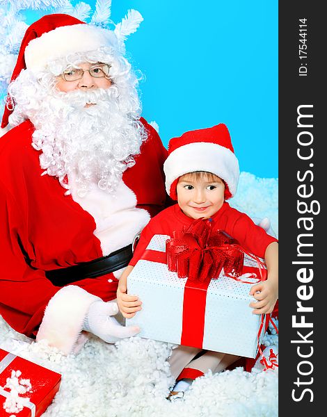 Christmas theme: Santa Claus and little boy with presents. Christmas theme: Santa Claus and little boy with presents.