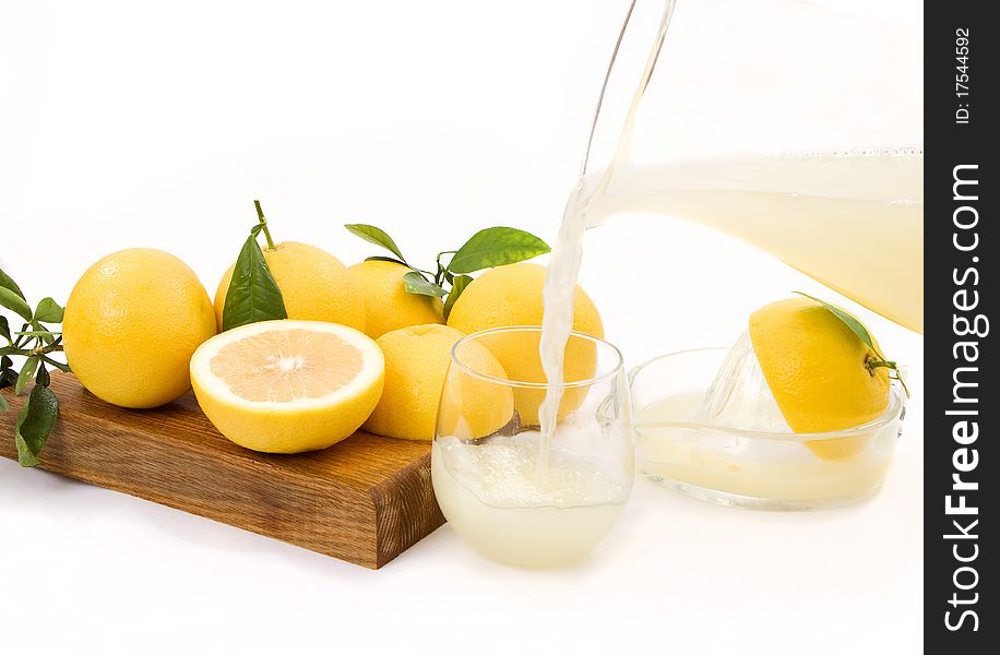 Freshly squeezed grapefruit juice being poured into a glass. Freshly squeezed grapefruit juice being poured into a glass