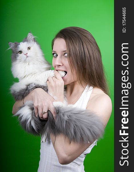 Girl and a cat on a green background isolated