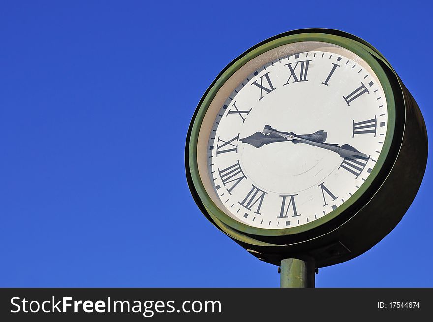 Vintage clock against a blue sky