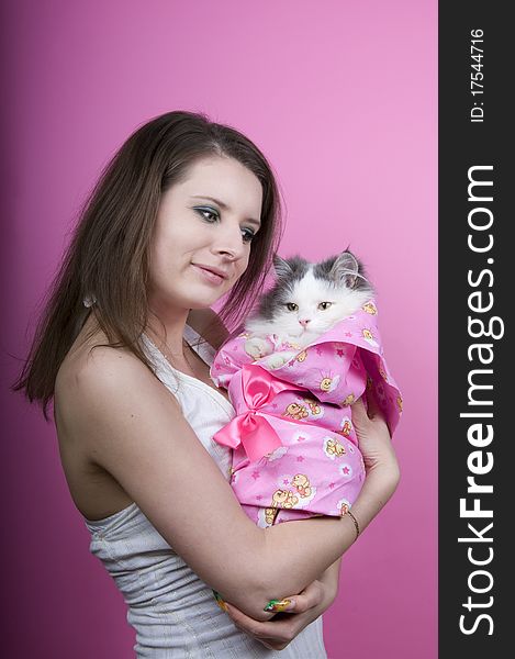 Girl and cat on a pink background isolated. Girl and cat on a pink background isolated