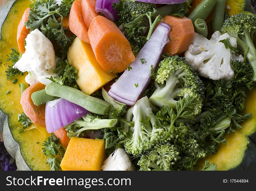 Mixed raw uncooked vegetables and spices stuffed in a pumpkin. Mixed raw uncooked vegetables and spices stuffed in a pumpkin