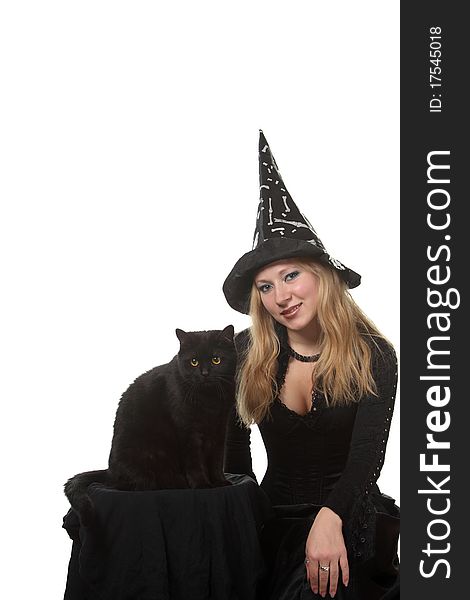 A young woman in a witch costume with a black cat. A young woman in a witch costume with a black cat