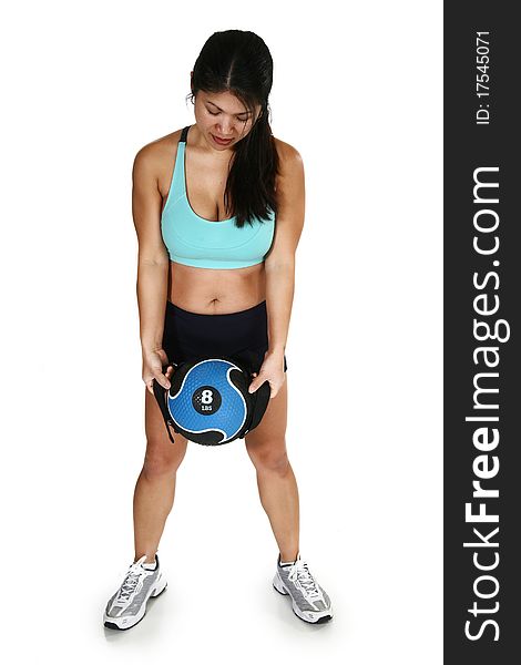 Beautiful 30 year old Filipino woman in workout clothes with medicine ball, over white background. Beautiful 30 year old Filipino woman in workout clothes with medicine ball, over white background.