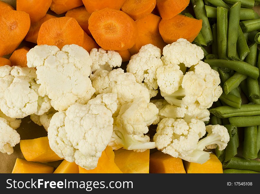 Mixed raw uncooked green beans, collyflower, pumpkin and carrots. Mixed raw uncooked green beans, collyflower, pumpkin and carrots