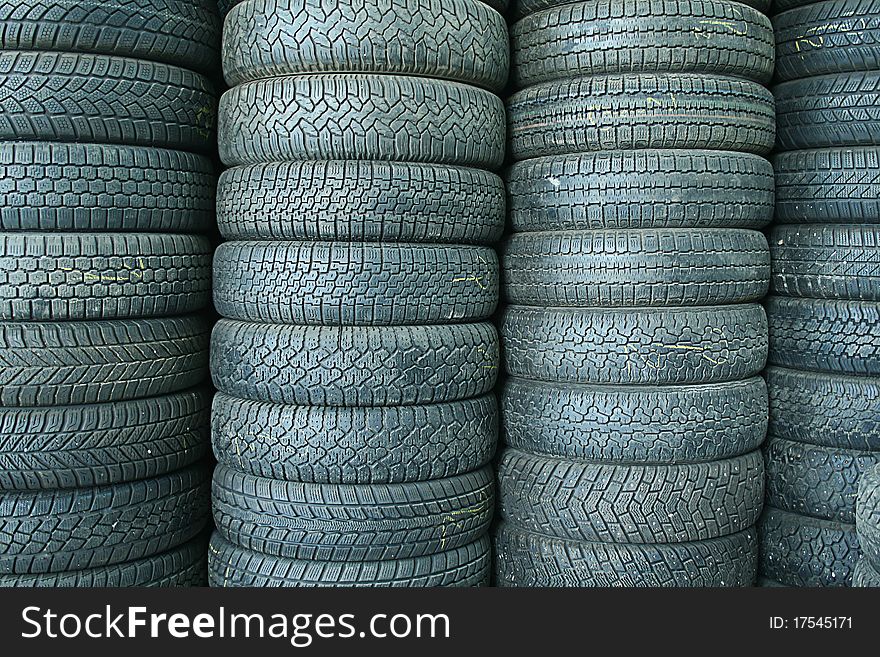 Stack of used tyres in a junkyard. Stack of used tyres in a junkyard