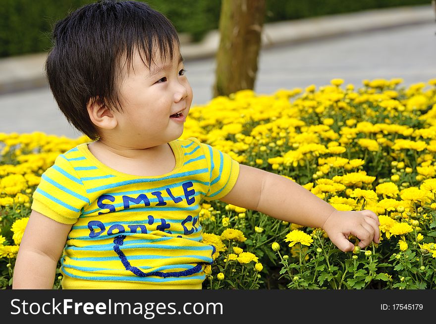 A happy baby is playing in garden