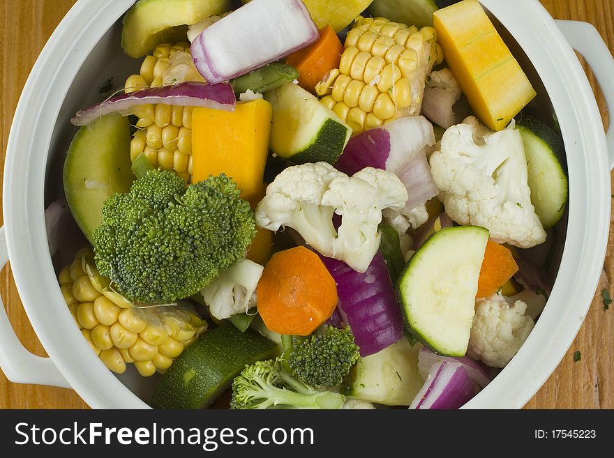 Sweetcorn, pumpkin, collyflower and mixed vegetables in a white bowl