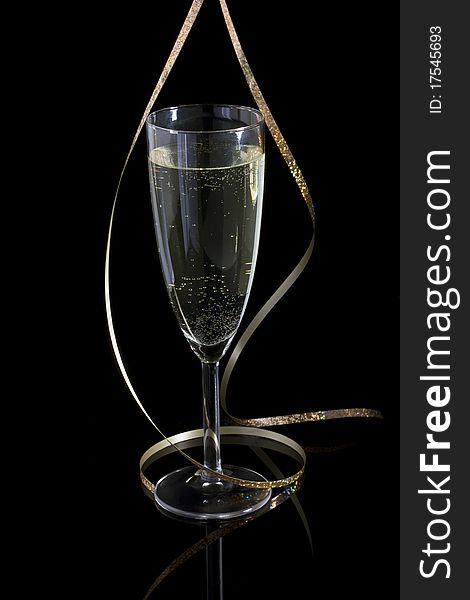 Glass with champagne and paper streamer. Glass with champagne and paper streamer