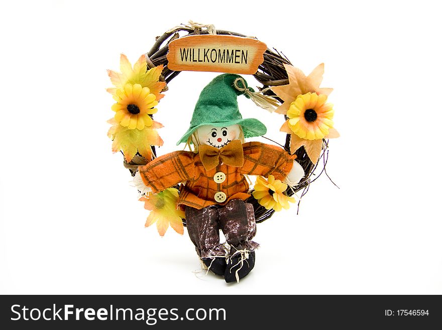 Door wreath with straw doll and welcome writing
