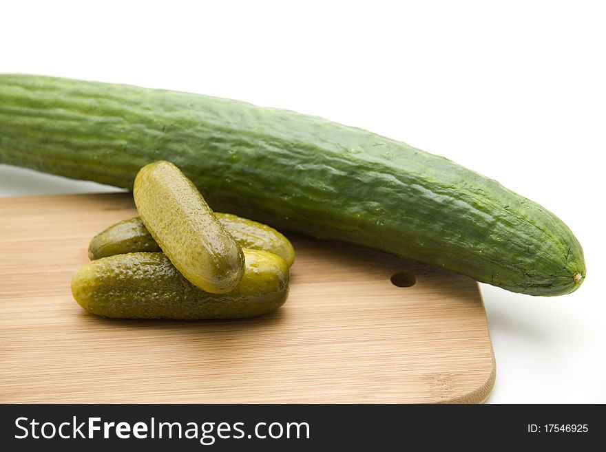 Gherkins on edge board with cucumber