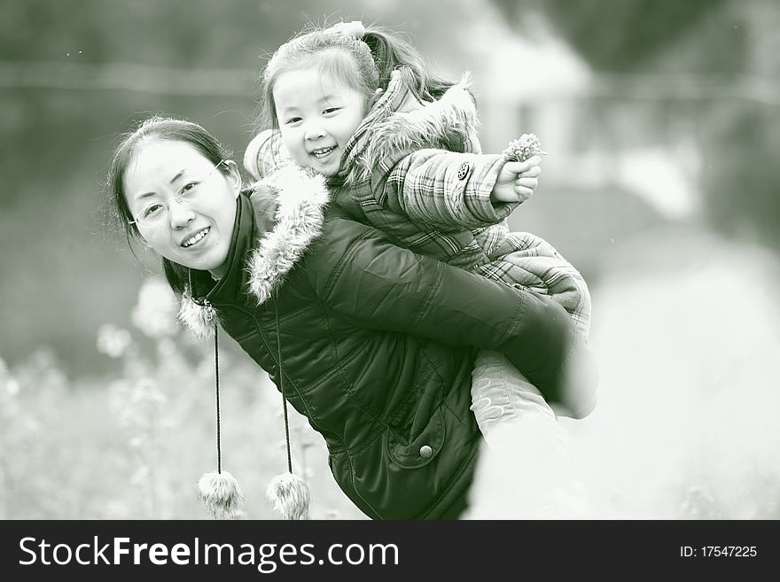 Mother and daughter playing in the outdoors, was taken in february 2010