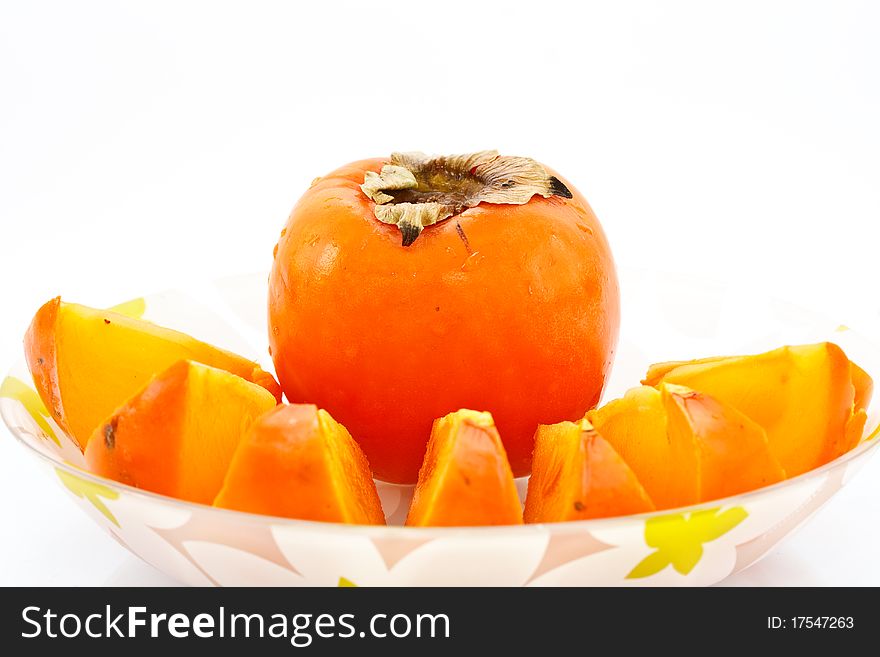 Persimmon in a dish on a white background