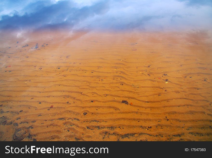 Reflection of the sky in the water over a sandy bottom. Reflection of the sky in the water over a sandy bottom