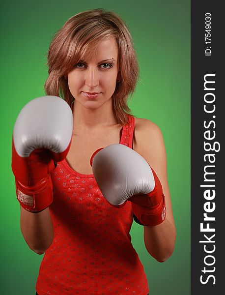 Beautiful young woman in boxing gloves