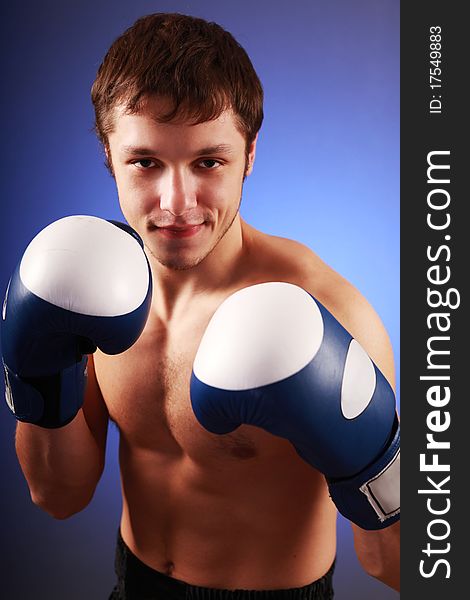 Young handsome boxer on blue background. Young handsome boxer on blue background