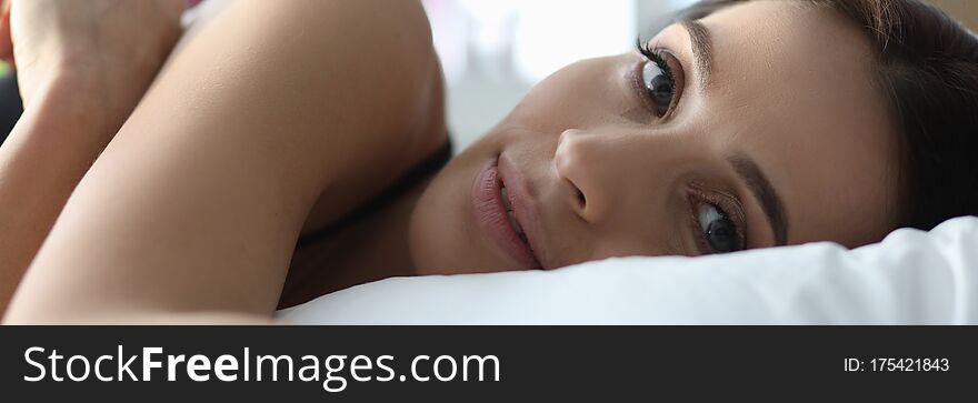 Portrait of female relaxing in bedroom. Morning of lady awakening from sleep. Young girl in her room, laying under blanket. Positive person on comfortable sofa. Portrait of female relaxing in bedroom. Morning of lady awakening from sleep. Young girl in her room, laying under blanket. Positive person on comfortable sofa