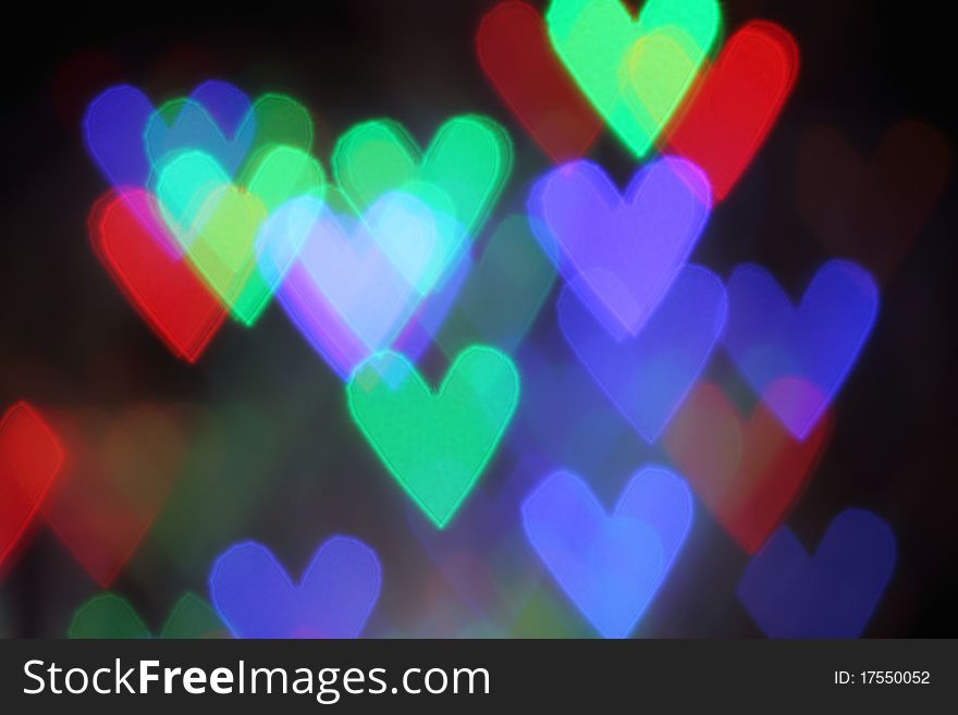 Blurred valentine background with heart shaped lights