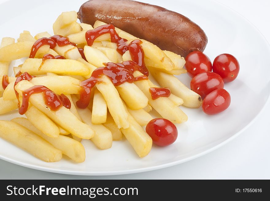 The fried potato is watered by ketchup with sausage and tomatoes.