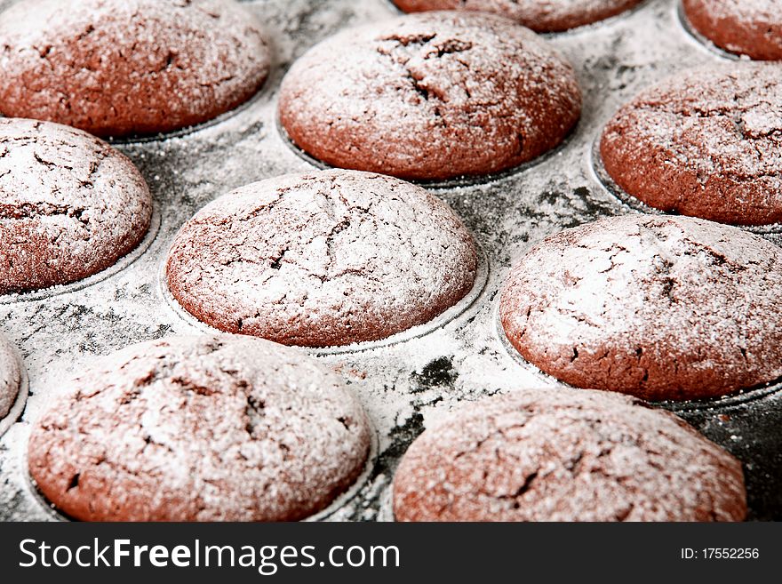 Chocolate muffins in baking tray - detail / closeup