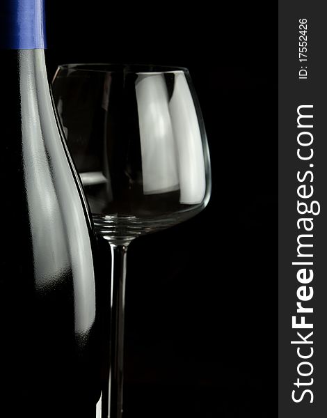 Wine glasses and wine bottle isolated over black background. Wine glasses and wine bottle isolated over black background