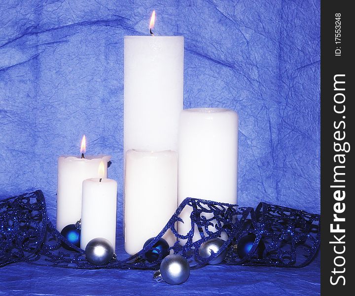 White candles with blue decorations