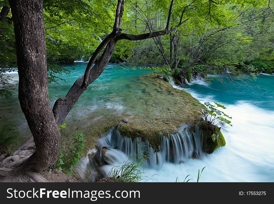 Waterfall and flowing water in a thick forest. Waterfall and flowing water in a thick forest