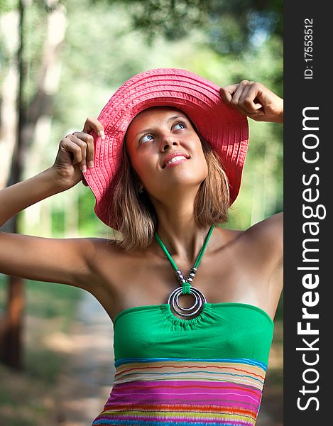 Portrait of beautiful young woman in pink hat