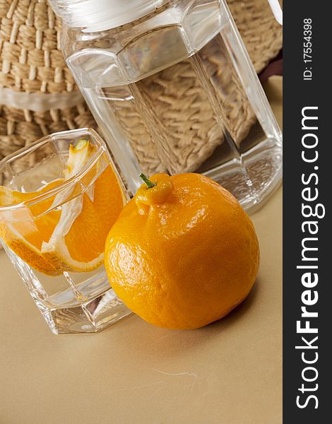 Oranges and glass cups, warm colors of the background