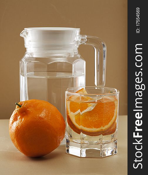 Oranges and glass cups, warm colors of the background
