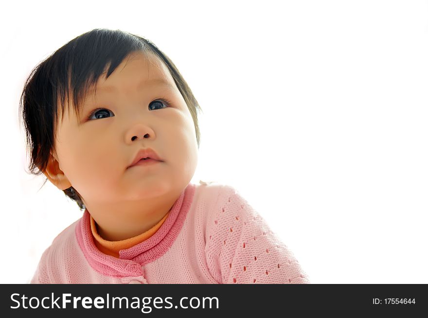 A Asian baby girl sitting on the bed