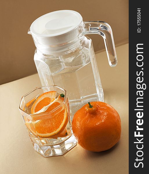 Oranges and glass cups, warm colors of the background