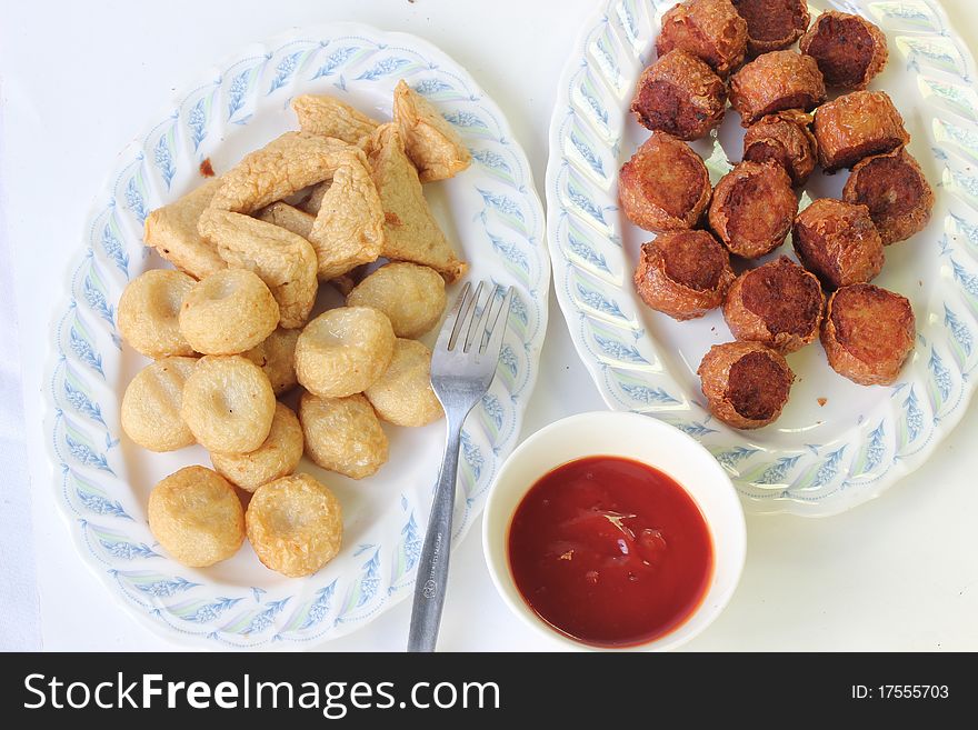 Fired meat ball with tomato sauce.