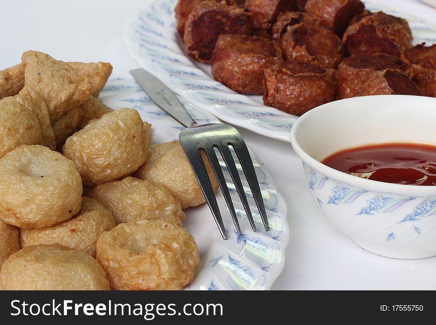 Fired meat ball with tomato sauce.