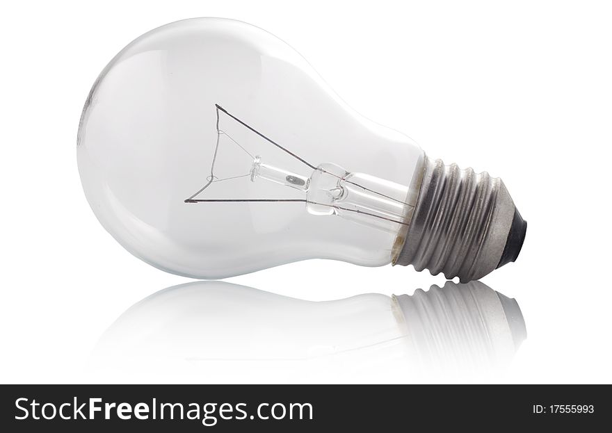 A single electric light bulb with its reflections on the floor isolated on white background. A single electric light bulb with its reflections on the floor isolated on white background