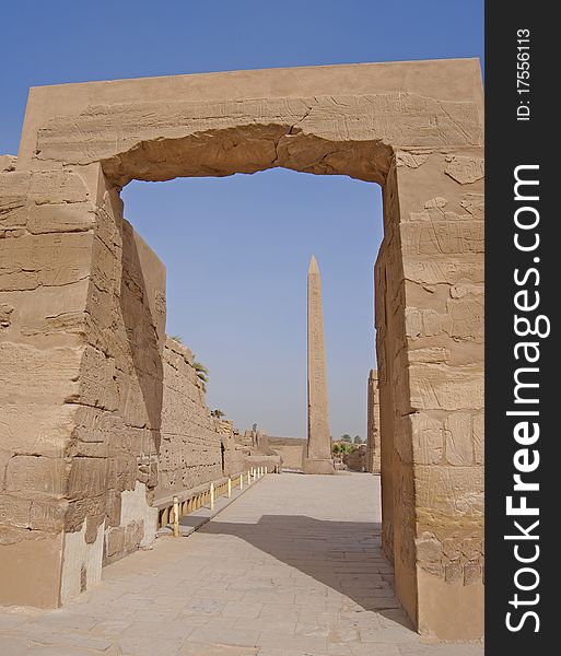 View of one of the obelisks at Karnak temple in Luxor through an archway. View of one of the obelisks at Karnak temple in Luxor through an archway