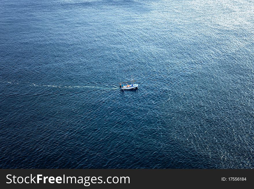 A lone boat in the deep blue sea