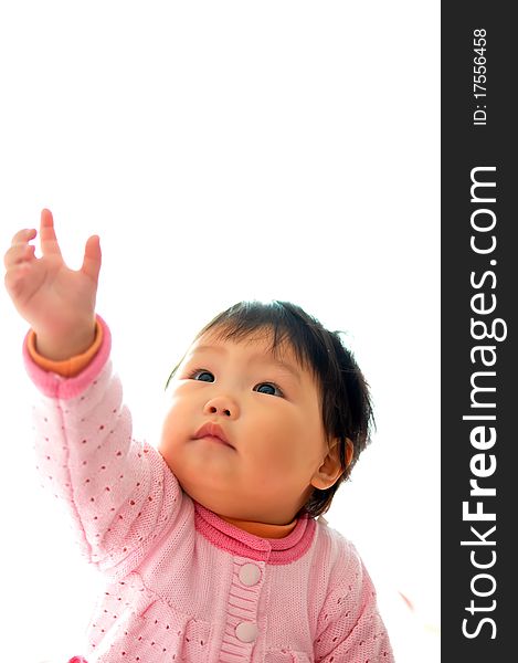 A Asian baby girl sitting on the bed。She wanted to catch a toy