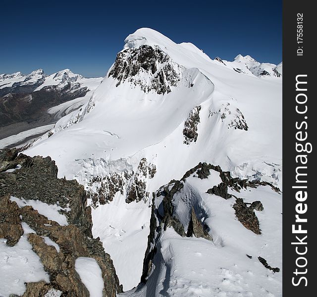 A view of a snowcovered mountain in the swiss alps. A view of a snowcovered mountain in the swiss alps