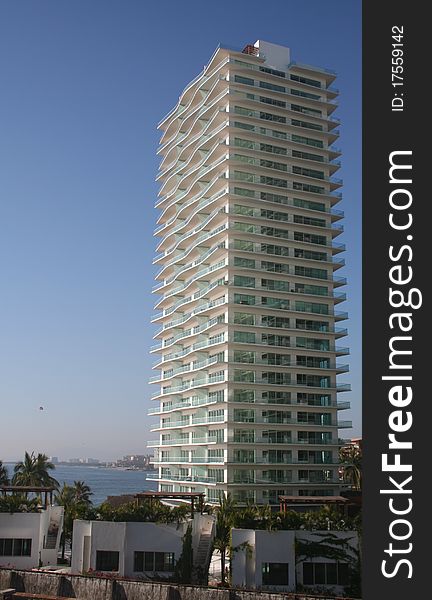 Scene along the Pacific coast of Mexico near Puerto Vallarta with a highrise building of vacation condominiums. Scene along the Pacific coast of Mexico near Puerto Vallarta with a highrise building of vacation condominiums.